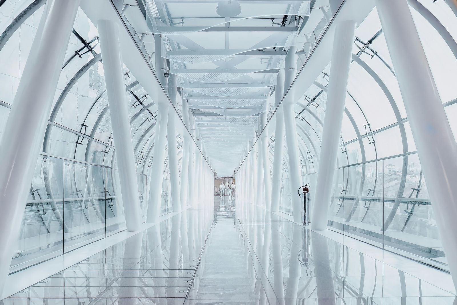 a man is walking down a long hallway