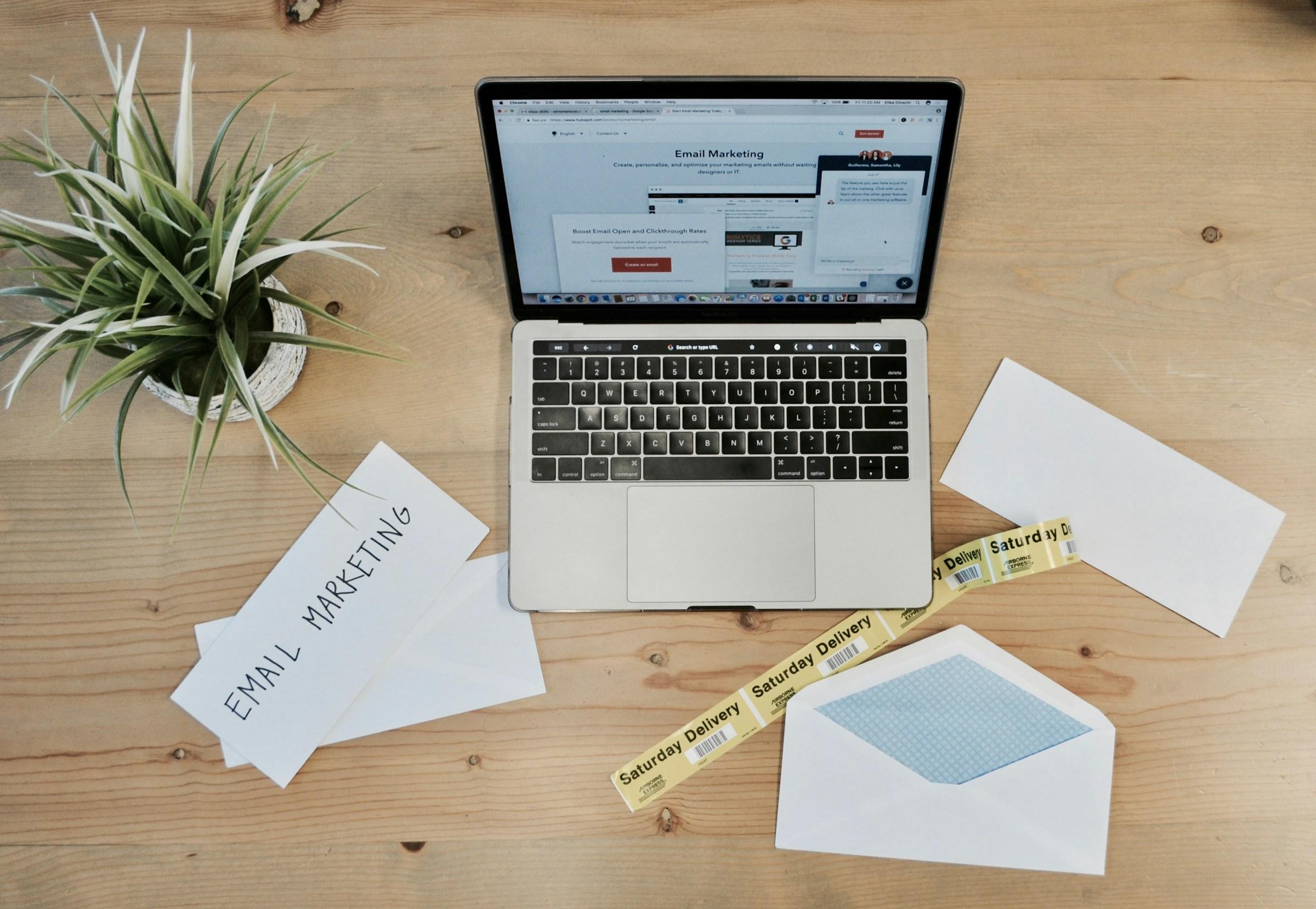 Modern marketing workspace with laptop and campaign planning materials representing streamlined campaign execution