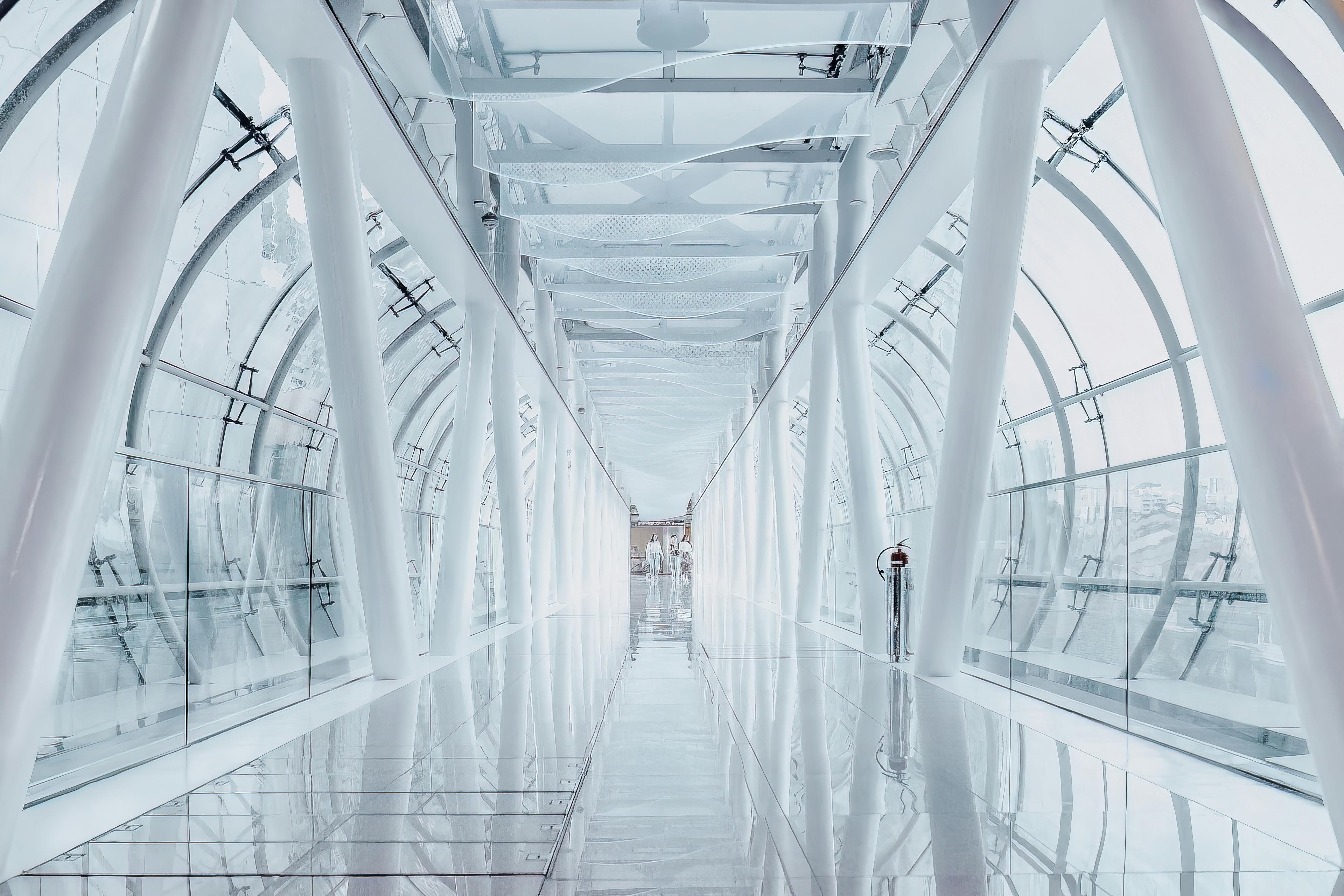 a man is walking down a long hallway