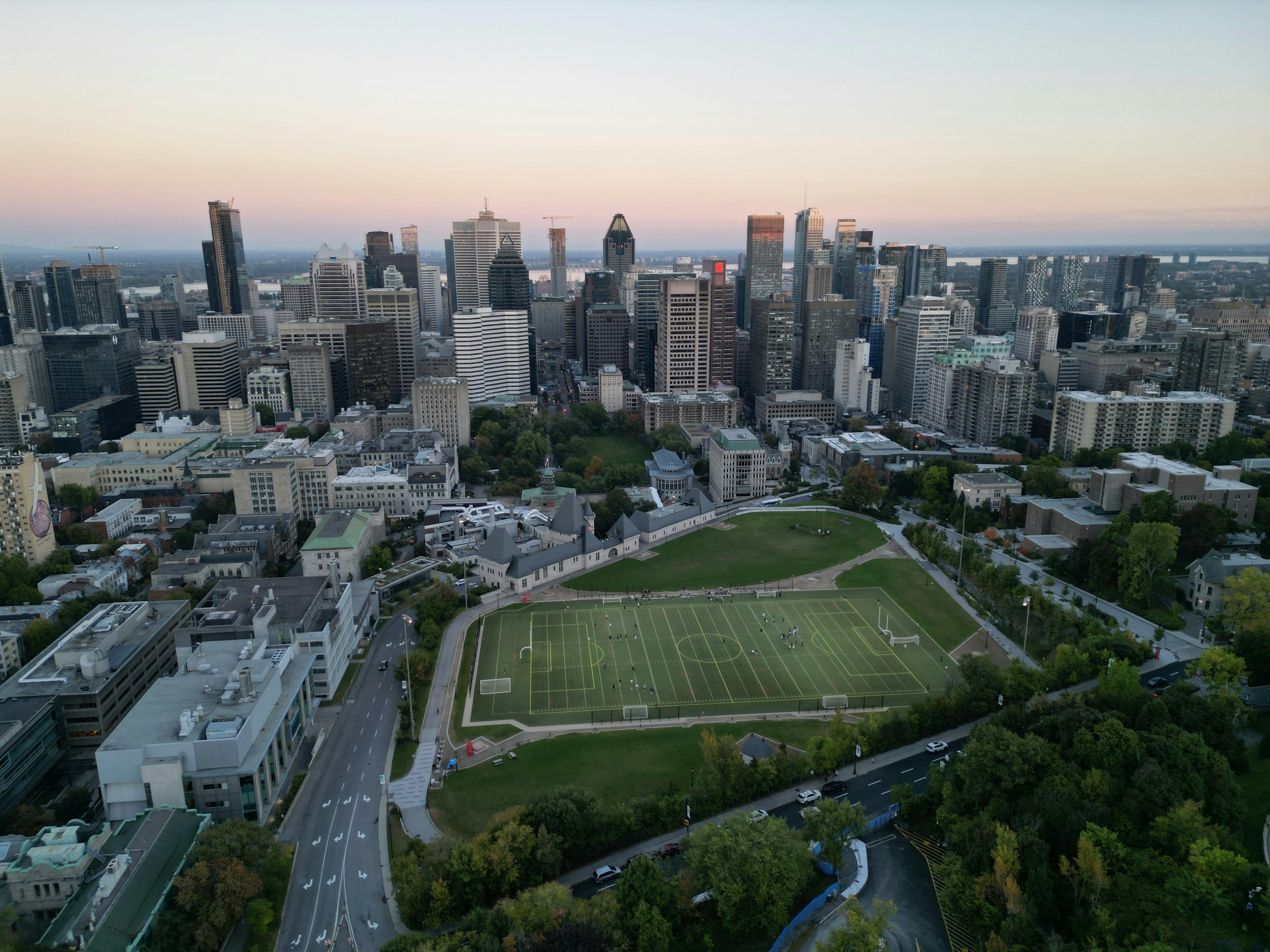 An aerial view of a city with a soccer field