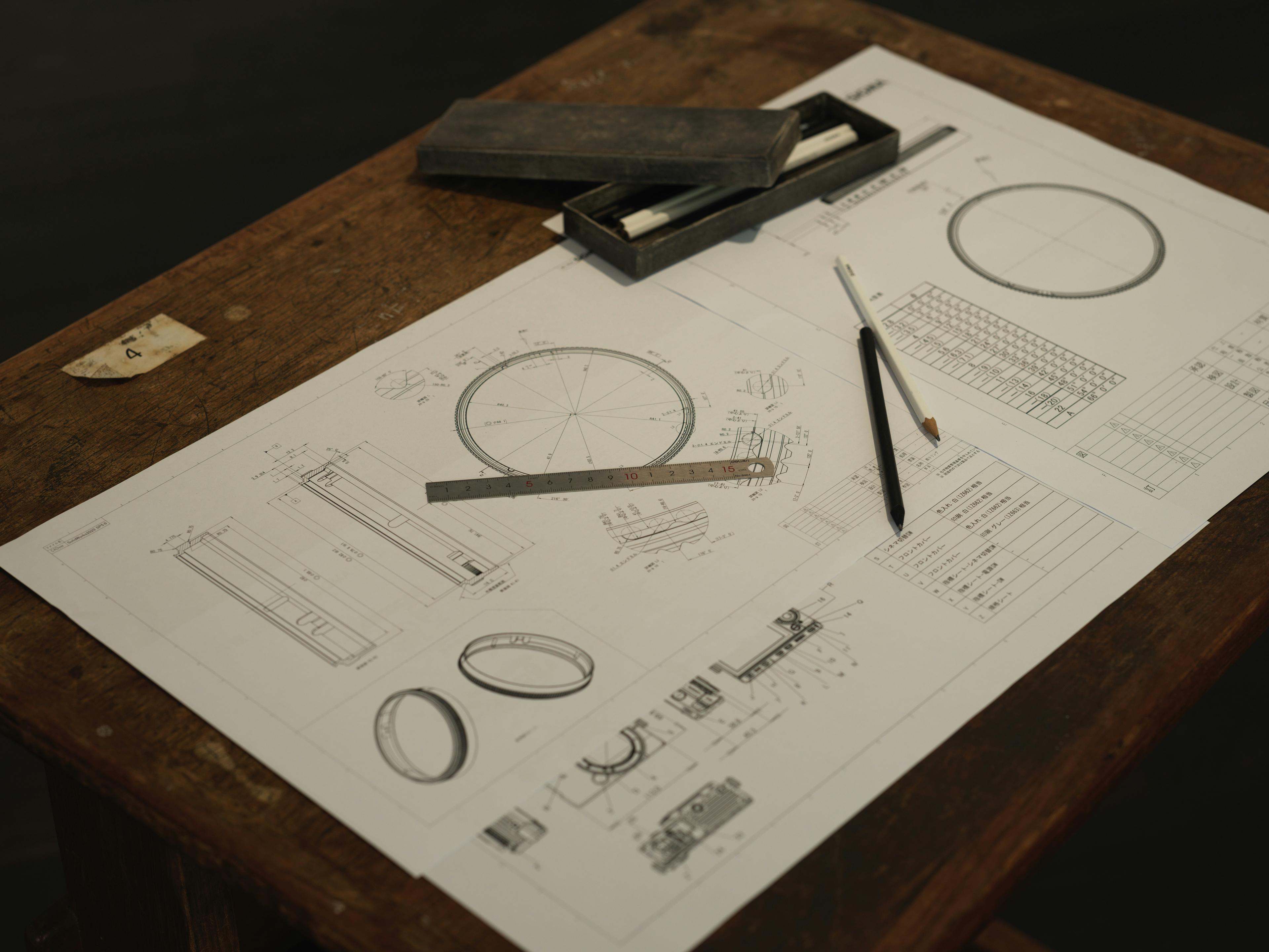 A wooden table topped with a piece of paper and a pair of scissors